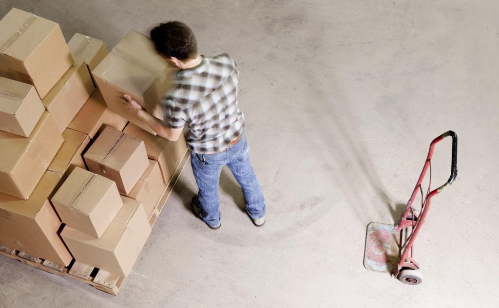 Man hammering nails into a wooden storage box