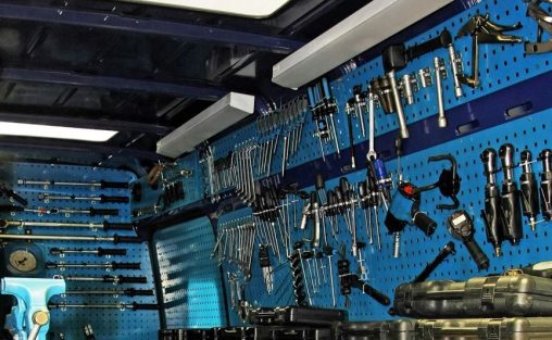 DIY tools and equipment on the back panel of a workbench