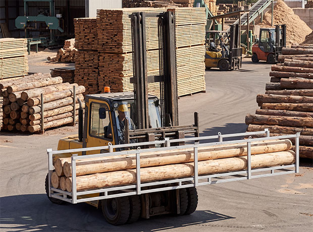 Pipe stillage loaded with timber on a forklift